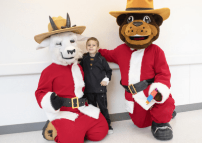 Range Riders pose with Logan Health Children's patient