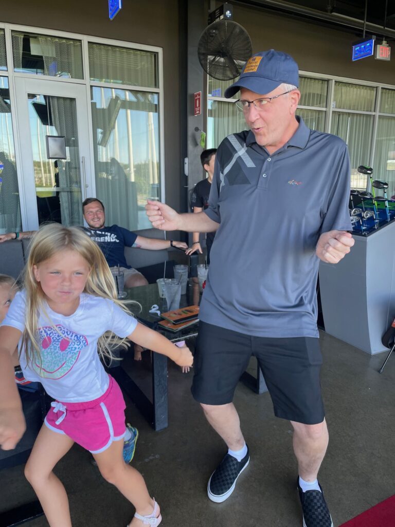 Greg Berger dances with his granddaughter