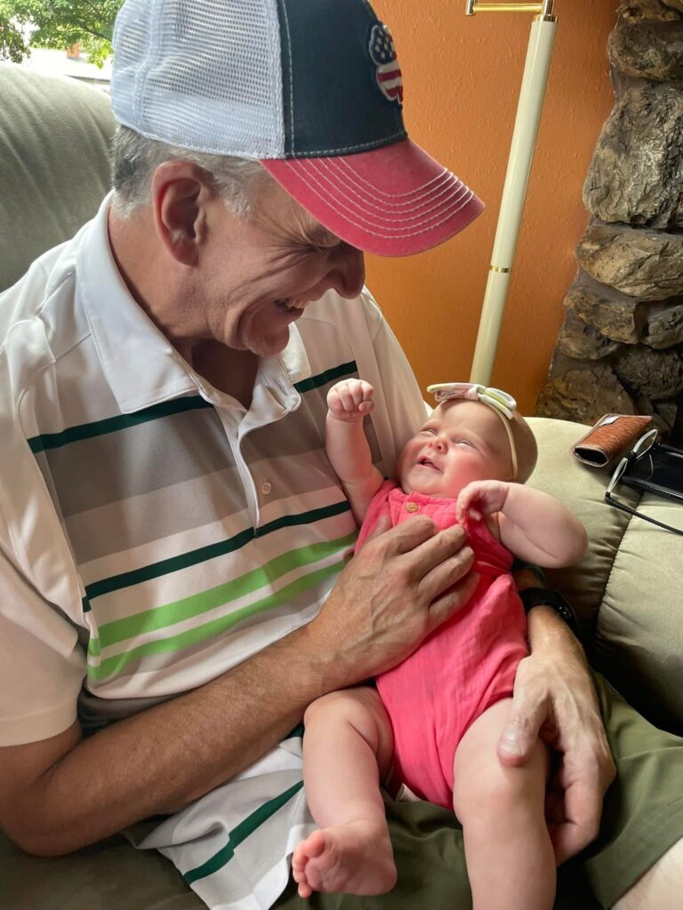 Greg Berger smiling with his granddaughter