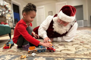 Sensory Santa plays cars with child_2023